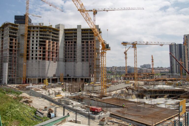 View of a bustling urban construction site with cranes and high-rise buildings.